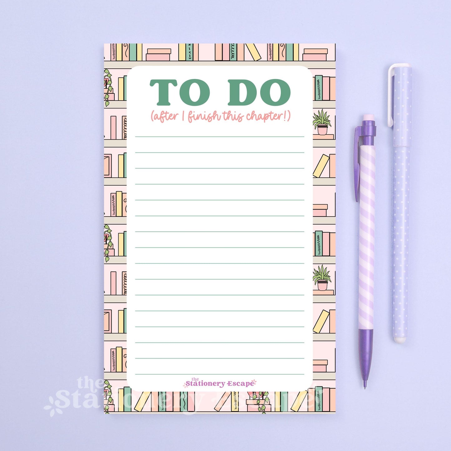 To-do list pad with book illustrations and a pen on a light purple background