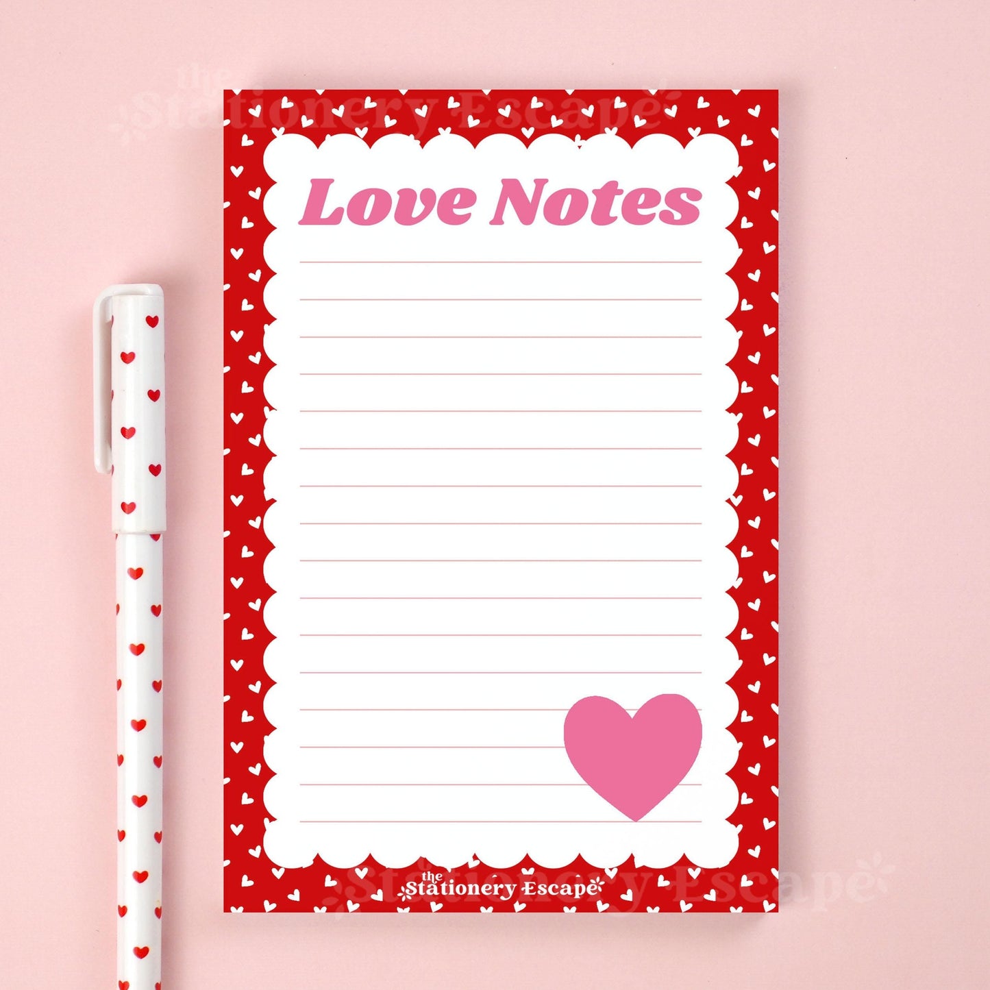 Notepad with 'Love Notes' text and heart design on a pink background, accompanied by a pen.