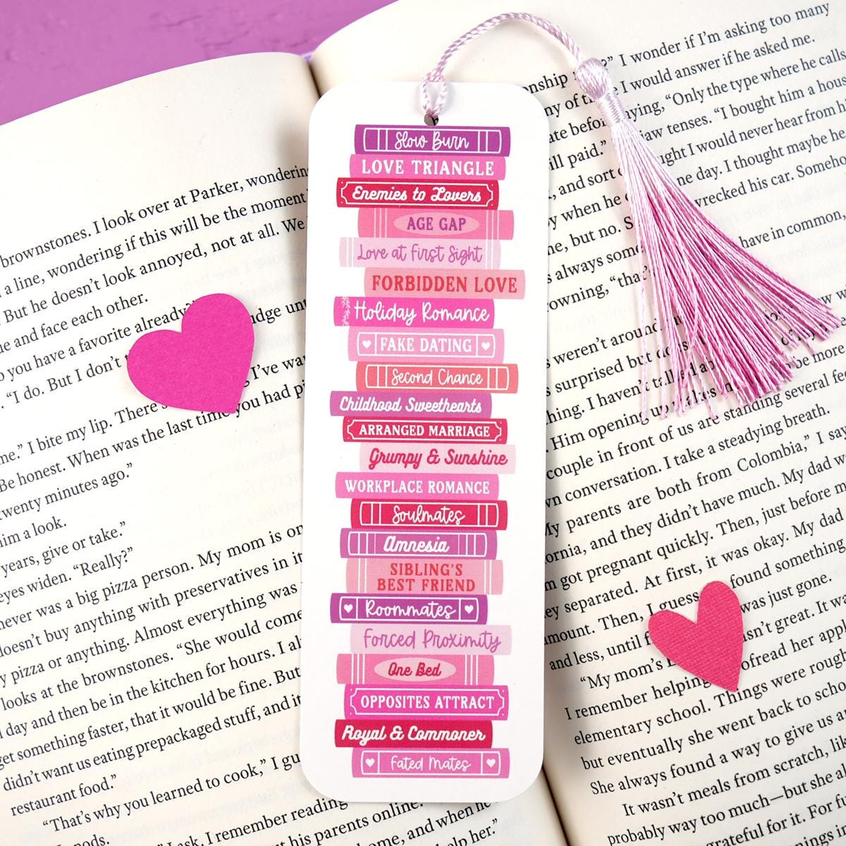 Pink bookmark with heart design on a book page