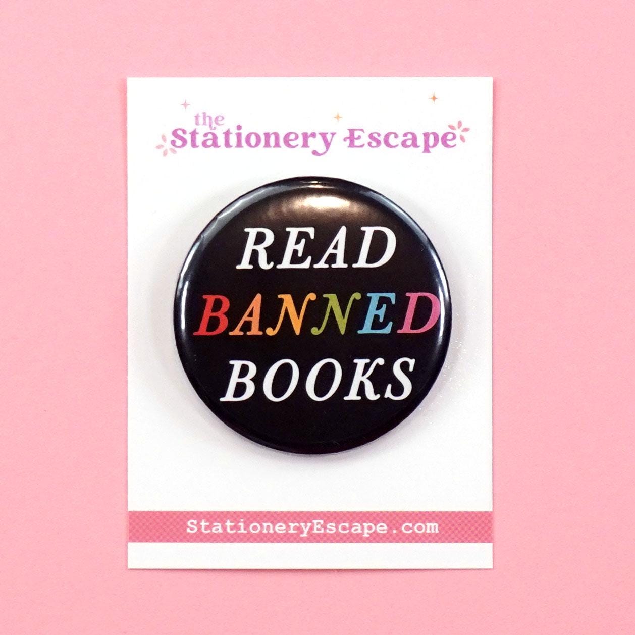 Black button badge with rainbow 'Read Banned Books' text on a pink background, featuring the brand 'The Stationery Escape'.