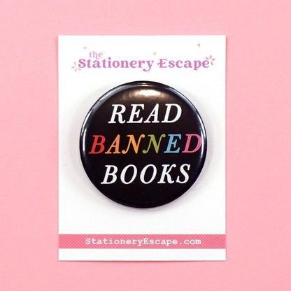 Black button badge with rainbow 'Read Banned Books' text on a pink background, featuring the brand 'The Stationery Escape'.