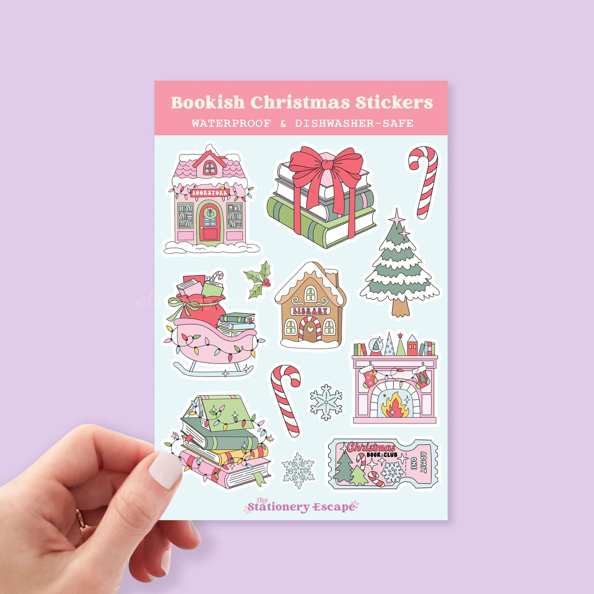 Sheet of bookish Christmas stickers held by a hand on a light purple background