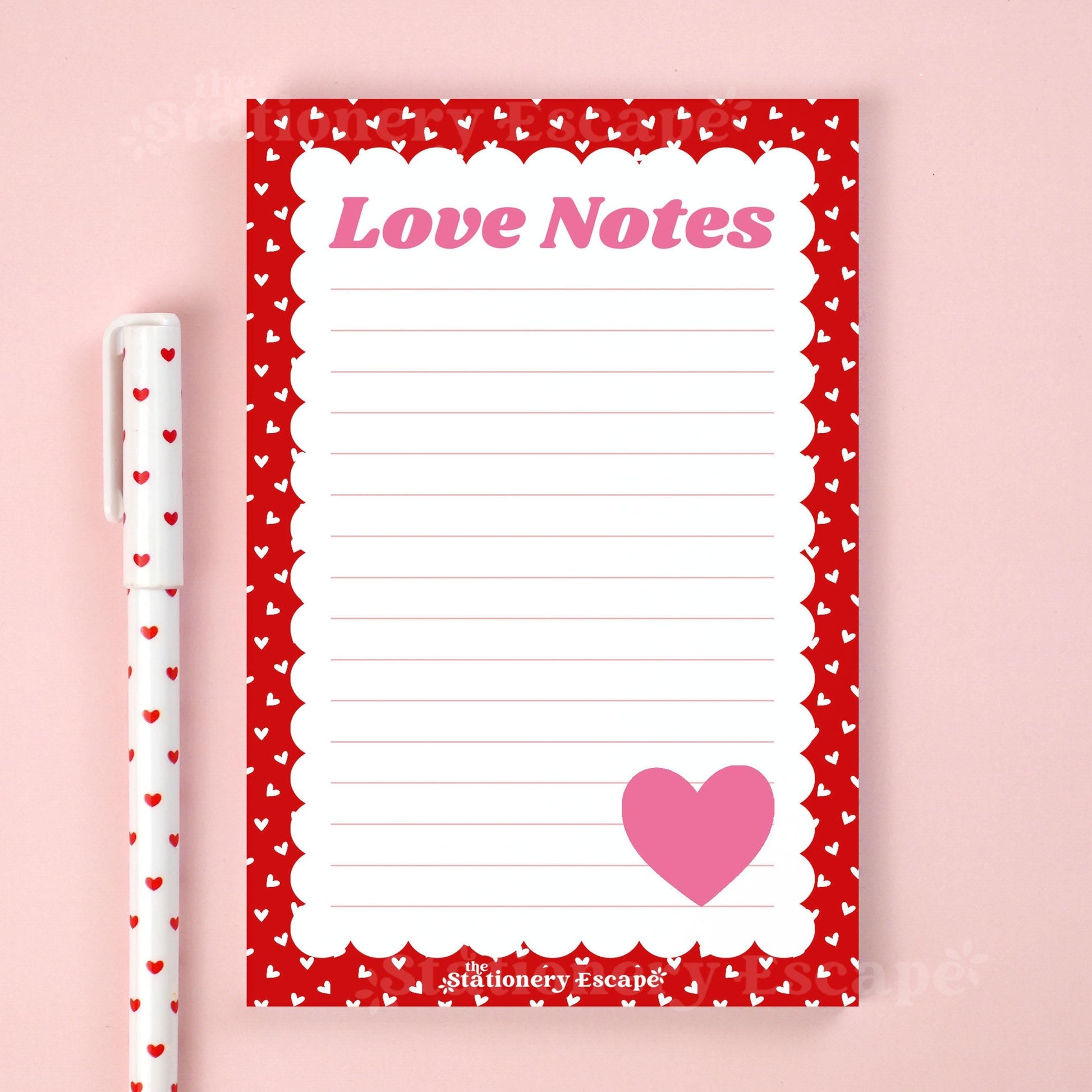 Notepad with 'Love Notes' text and heart design on a pink background, accompanied by a pen.