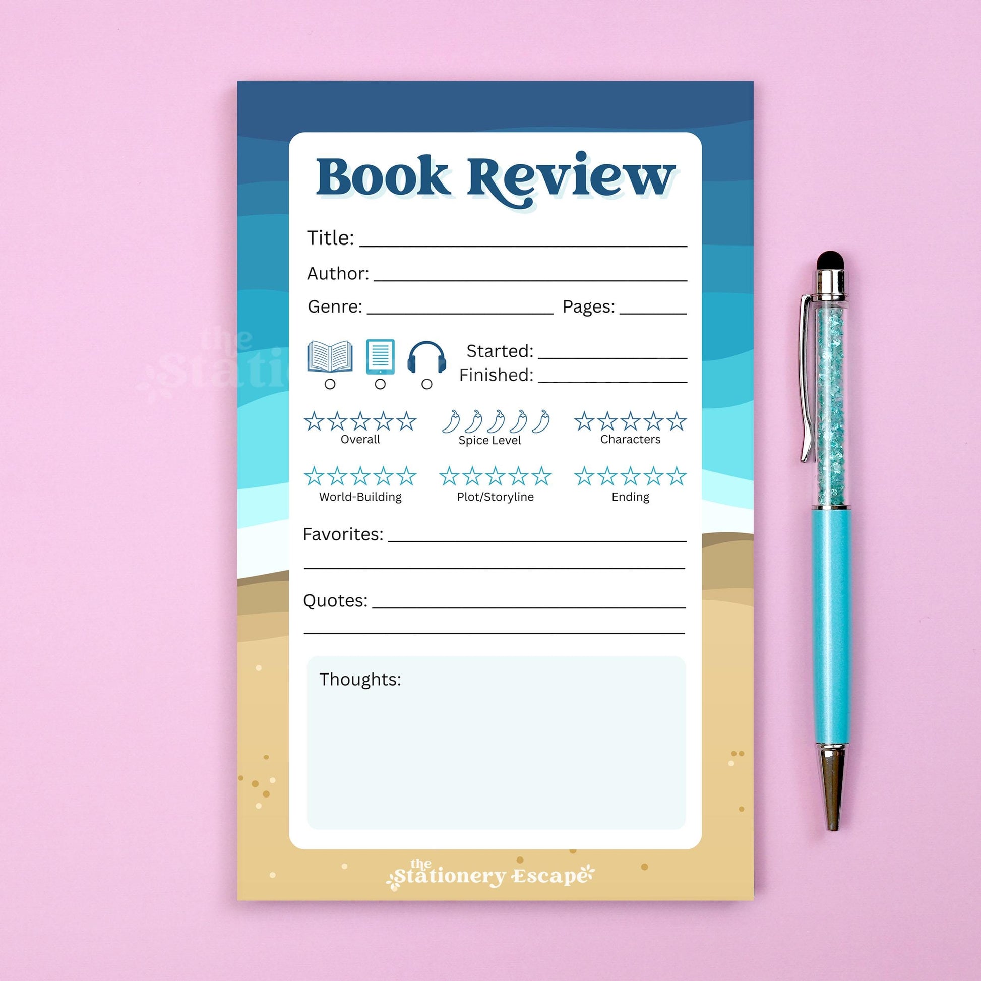 Blue and tan beach-themed book review notepad with a pen on a pink background