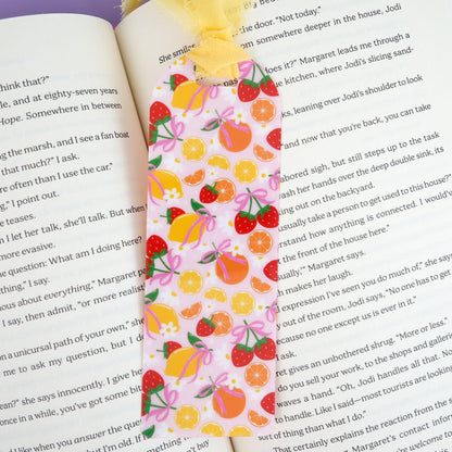 Colorful fruit patterned bookmark on an open book