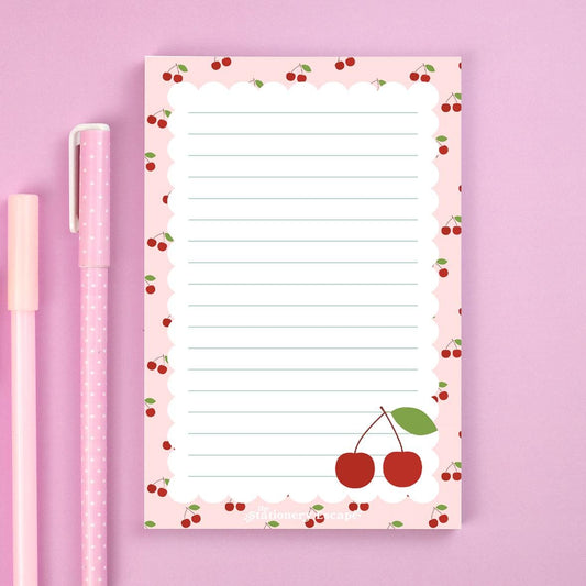 Notepad with cherry design on a pink background