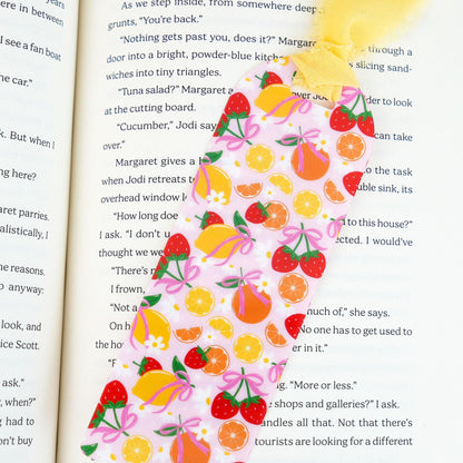 Decorative bookmark with fruit pattern on an open book