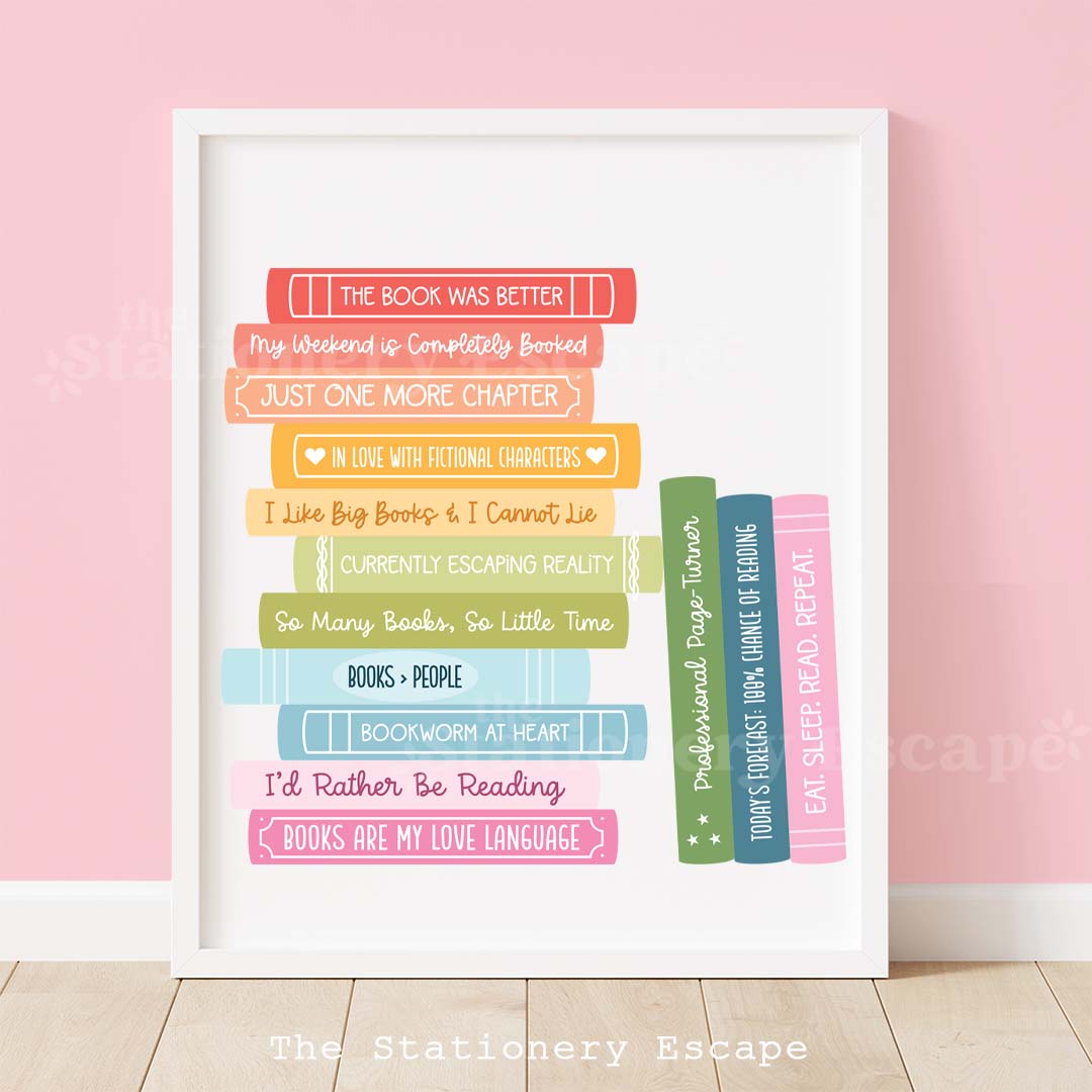 Framed rainbow book stack art print featuring colorful book spines with popular book puns and phrases. 
