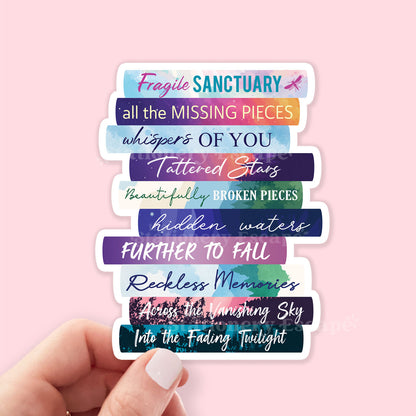 Book Stack sticker in hand featuring the works of Catherine Cowles in colorful book spines on pink background