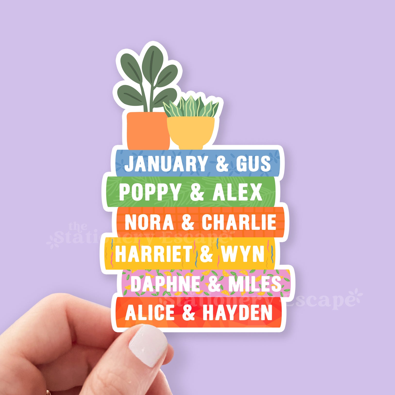 Stack of colorful Emily Henry book spines on a sticker held by a hand on a purple background