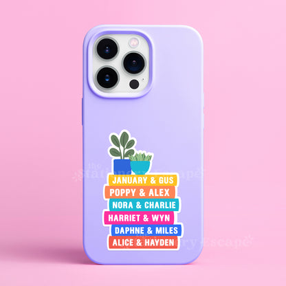 Purple phone case with Emily Henry book stack sticker on a pink background