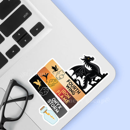 Fourth Wing Book Stack and dragon sticker on laptop