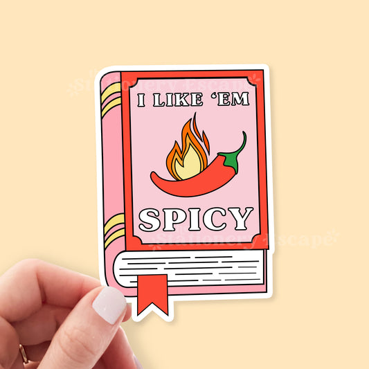 Sticker with a book design and 'I like 'em spicy' text on a beige background