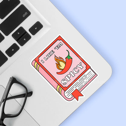 Book sticker with a chili pepper and "I Like 'Em Spicy" text on a laptop
