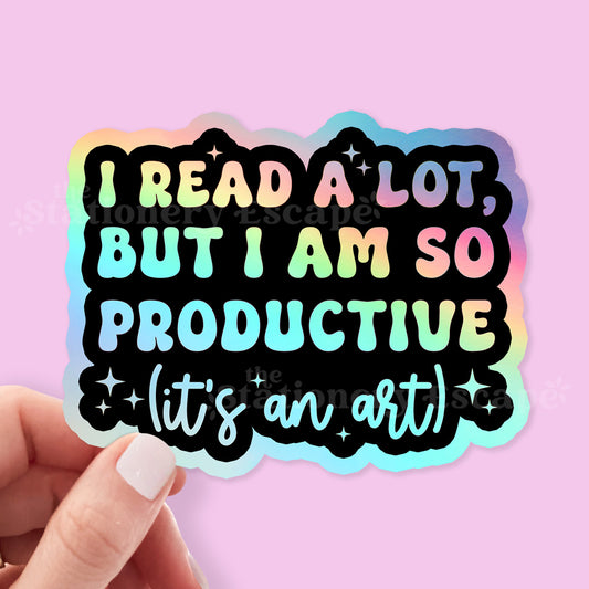 Holographic sicker with colorful "I Read a Lot But I am So Productive (It's an Art)" text on a pink background