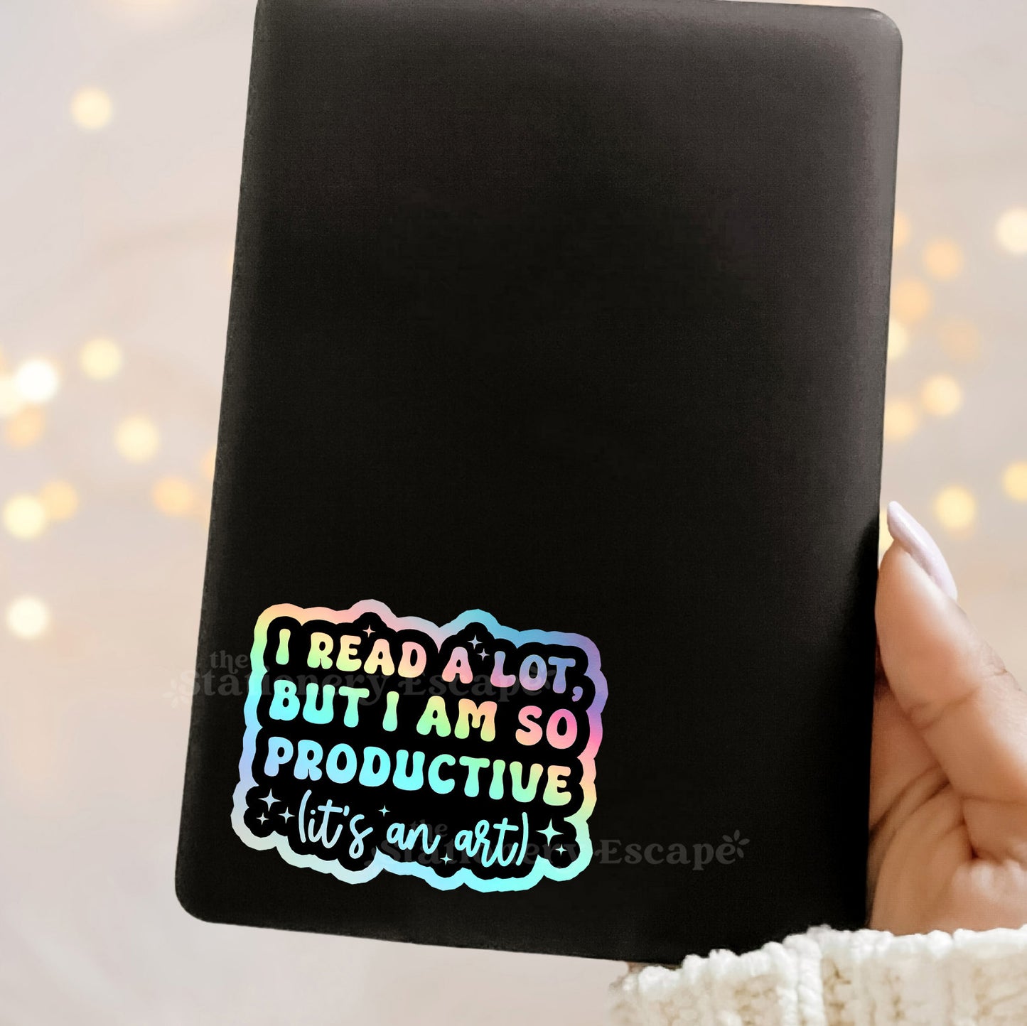 Black Kindle with Holographic sicker with colorful "I Read a Lot But I am So Productive (It's an Art)" text 