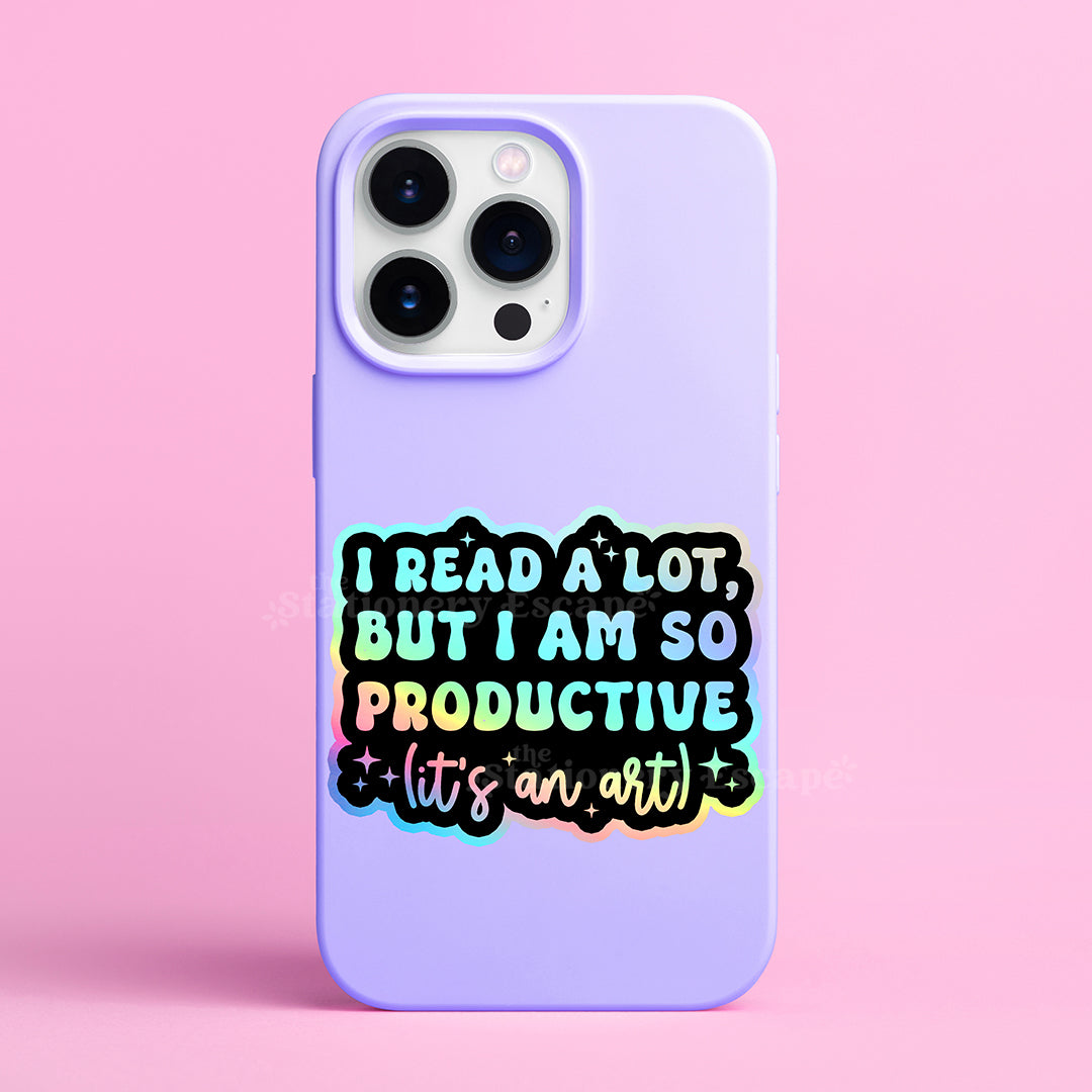 Holographic sicker with colorful "I Read a Lot But I am So Productive (It's an Art)" text on a purple cell phone case on a pink background