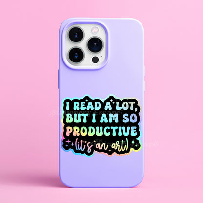 Holographic sicker with colorful "I Read a Lot But I am So Productive (It's an Art)" text on a purple cell phone case on a pink background