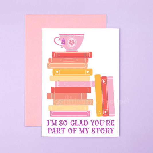 Stack of books with a teacup on top, set against a purple background