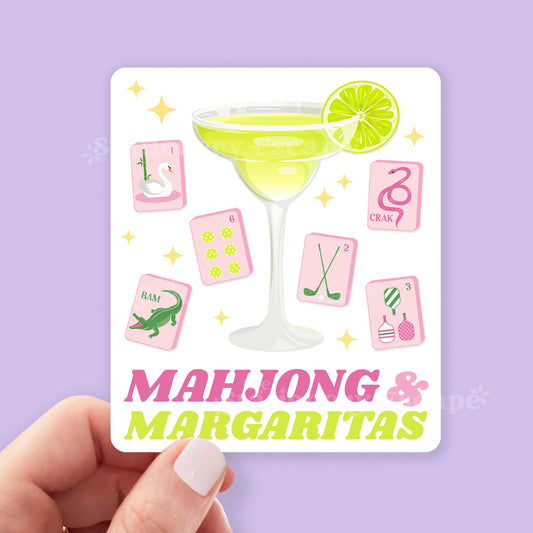 White sticker with a cocktail and mahjong tiles on a purple background, featuring the text 'Mahjong & Margaritas'.