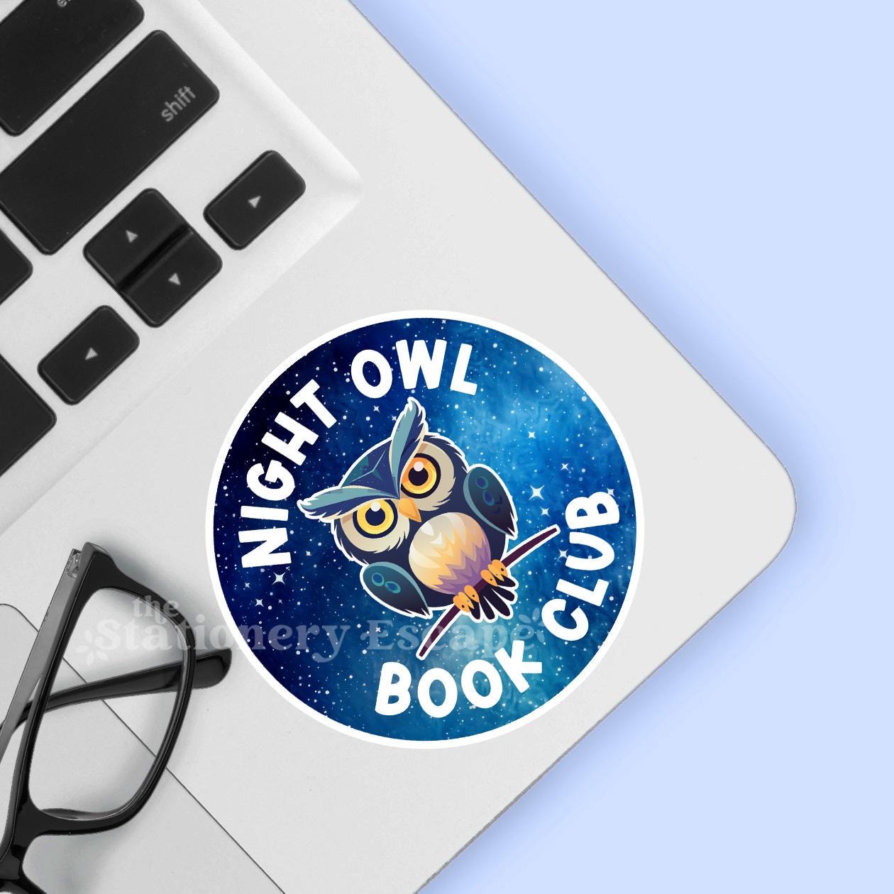 Sticker with owl design and 'Night Owl Book Club' text on a laptop