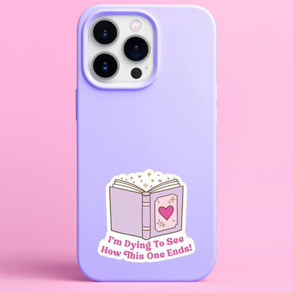 Phone case with a book sticker and text on a pink background