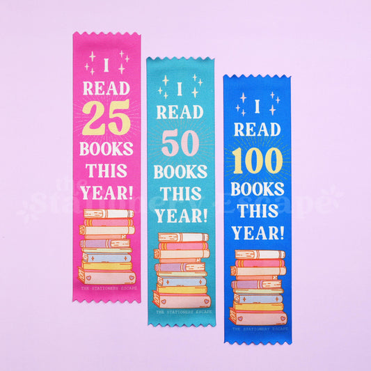 Three colorful bookmarks indicating reading achievements on a light purple background