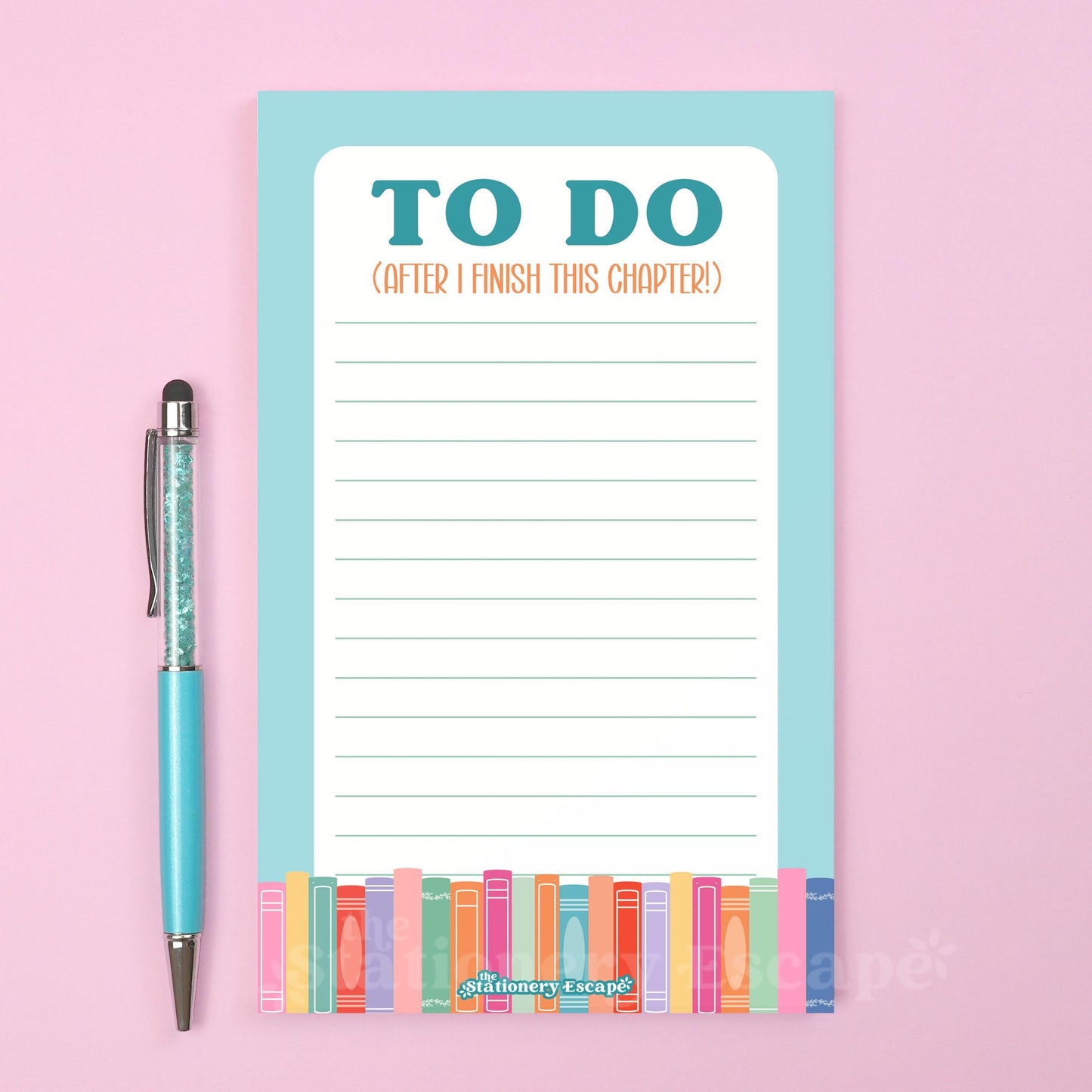 Notepad with 'To Do' list and blue border with colorful books and pen on a pink background